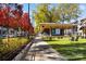 Outdoor park with a stage for events, lounge chairs on artificial turf, autumn foliage and sidewalk at 7409 Gilderstern Glen Ct, Huntersville, NC 28078