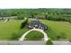 An elevated view of a home with a large, manicured lawn and a winding driveway at 767 Pinnacle Dr, Iron Station, NC 28080