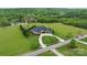 Aerial view of a luxurious home with a sprawling lawn and circular driveway at 767 Pinnacle Dr, Iron Station, NC 28080