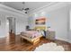 Bright bedroom with hardwood floors, tray ceiling, and colorful décor at 767 Pinnacle Dr, Iron Station, NC 28080