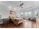 Bright bedroom with hardwood floors, tray ceiling, and large windows letting in lots of natural light at 767 Pinnacle Dr, Iron Station, NC 28080