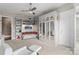 Cozy bedroom featuring custom built-in shelving, mirrored closet, and a comfortable sitting area at 767 Pinnacle Dr, Iron Station, NC 28080