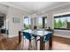 Bright dining room featuring stylish light fixture, large windows with a lovely view, and blue chairs at 767 Pinnacle Dr, Iron Station, NC 28080