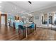 Open concept dining room with views of the kitchen and backyard through large windows and sliding glass doors at 767 Pinnacle Dr, Iron Station, NC 28080