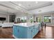 Open-concept kitchen with a spacious island, blue cabinetry, and seamless access to living spaces at 767 Pinnacle Dr, Iron Station, NC 28080