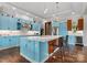 Spacious kitchen features a large island with seating, stainless steel appliances, and custom blue cabinetry at 767 Pinnacle Dr, Iron Station, NC 28080