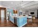 Bright, open kitchen features a large island, stainless steel appliances and a view into the living room at 767 Pinnacle Dr, Iron Station, NC 28080