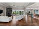 Spacious living room with hardwood floors, modern furnishings, and expansive glass doors leading to the outside at 767 Pinnacle Dr, Iron Station, NC 28080