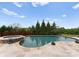 Serene backyard pool featuring elegant landscaping, a built-in hot tub, and peaceful views of the surrounding nature at 767 Pinnacle Dr, Iron Station, NC 28080