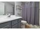 A functional bathroom features a vanity, toilet, and shower with gray accents and towel rack at 825 21St Ne Ave, Hickory, NC 28601