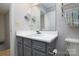 A stylish bathroom vanity has gray cabinets, a white countertop, and a decorative mirror at 825 21St Ne Ave, Hickory, NC 28601