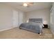 A cozy bedroom featuring a gray bed, plush carpet, and ample natural light through a side window at 825 21St Ne Ave, Hickory, NC 28601