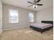 A bright bedroom features a dark bed, with two windows for natural light and neutral walls at 825 21St Ne Ave, Hickory, NC 28601