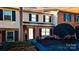 Charming two-story brick townhome with black shutters and manicured landscaping at 825 21St Ne Ave, Hickory, NC 28601