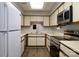 Well-lit kitchen with white cabinets, stainless appliances, and plenty of counter space at 825 21St Ne Ave, Hickory, NC 28601