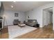 Cozy living room features gray sofa and chair, with sleek coffee table and fireplace at 825 21St Ne Ave, Hickory, NC 28601