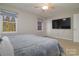 Inviting bedroom with ceiling fan, tv and natural light from two windows at 825 21St Ne Ave, Hickory, NC 28601