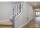 Staircase with carpeted steps and white banister at 825 21St Ne Ave, Hickory, NC 28601