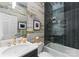 Stylish bathroom with a shower-tub combo, modern fixtures, and trendy wallpaper at 974 Queens Rd, Charlotte, NC 28207