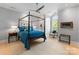 Inviting bedroom boasts a four-poster bed, a ceiling fan, and a large window offering bright, natural light at 974 Queens Rd, Charlotte, NC 28207