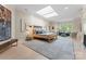 Bedroom with a skylight, decorative art, and a cozy seating area at 974 Queens Rd, Charlotte, NC 28207