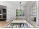 Chic dining area with modern lighting, a comfortable bench, and a view of the backyard at 974 Queens Rd, Charlotte, NC 28207