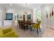 Bright dining room with modern chandelier, large window and artistic decor with hardwood floors at 974 Queens Rd, Charlotte, NC 28207