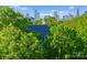 Elegant home nestled among trees, with a glimpse of the city skyline at 974 Queens Rd, Charlotte, NC 28207
