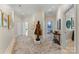 Spacious hallway featuring neutral walls, wood floors, and decorative art and statues at 974 Queens Rd, Charlotte, NC 28207