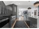 Modern kitchen with stainless appliances, decorative backsplash, and an open view to the living area at 974 Queens Rd, Charlotte, NC 28207