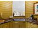 Unique wet bar with marble countertops, copper sink, and stylish fixtures adds a touch of elegance at 974 Queens Rd, Charlotte, NC 28207