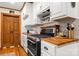 Updated kitchen with custom cabinets, hardwood countertops, and stainless steel appliances at 10139 Arlington Church Rd, Mint Hill, NC 28227
