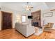 Cozy living room featuring a brick fireplace, hardwood floors, and comfortable seating at 10139 Arlington Church Rd, Mint Hill, NC 28227