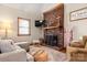 Comfortable living room with brick fireplace, hardwood floors, and a cozy seating area for relaxation at 10139 Arlington Church Rd, Mint Hill, NC 28227