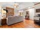 Bright living room with hardwood floors, brick fireplace, and ample seating in a vaulted ceiling room at 10139 Arlington Church Rd, Mint Hill, NC 28227