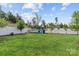 Spacious backyard featuring lush green grass, a playset, and a white fence for added privacy at 106 Wrangler Dr, Mooresville, NC 28115