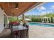 Inviting outdoor space with covered patio, dining, lounge area, and a pristine swimming pool at 106 Wrangler Dr, Mooresville, NC 28115