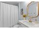 Light bathroom with a white shower curtain, stylish mirror, and single sink vanity at 106 Wrangler Dr, Mooresville, NC 28115