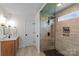 Elegant bathroom with a glass-enclosed shower, modern fixtures, and a wooden vanity at 106 Wrangler Dr, Mooresville, NC 28115
