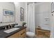 Well-lit bathroom featuring a single vanity and a shower-tub combination at 106 Wrangler Dr, Mooresville, NC 28115
