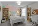 Cozy bedroom with a geometric accent wall, bookshelves, and a comfortable bed at 106 Wrangler Dr, Mooresville, NC 28115
