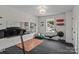 Bright exercise room with a treadmill, rowing machine, and mirrored wall at 106 Wrangler Dr, Mooresville, NC 28115