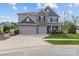 Charming two-story home with stone accents, a three-car garage, and well-maintained landscaping at 106 Wrangler Dr, Mooresville, NC 28115