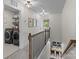 Upstairs hallway with laundry room and view into dining area at 106 Wrangler Dr, Mooresville, NC 28115