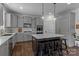 Bright and airy kitchen featuring gray cabinets, a center island, and stainless steel appliances at 106 Wrangler Dr, Mooresville, NC 28115