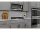 Close-up of a modern kitchen with sleek gray cabinets and updated appliances at 106 Wrangler Dr, Mooresville, NC 28115