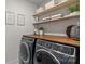 Laundry room featuring modern washer and dryer, ample counter space, and stylish decor at 106 Wrangler Dr, Mooresville, NC 28115