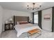 Well-lit main bedroom featuring a large bed, stylish decor, and comfortable furnishings at 106 Wrangler Dr, Mooresville, NC 28115