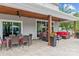 Covered patio featuring outdoor dining, a cozy lounge area, and seamless access to the backyard at 106 Wrangler Dr, Mooresville, NC 28115