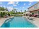 Beautifully landscaped pool with umbrella seating, lounge chairs, and lush green backyard at 106 Wrangler Dr, Mooresville, NC 28115